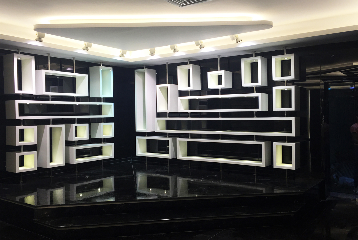 Innovative display shelves with geometric shapes on
						 a black wall for a modern office interior