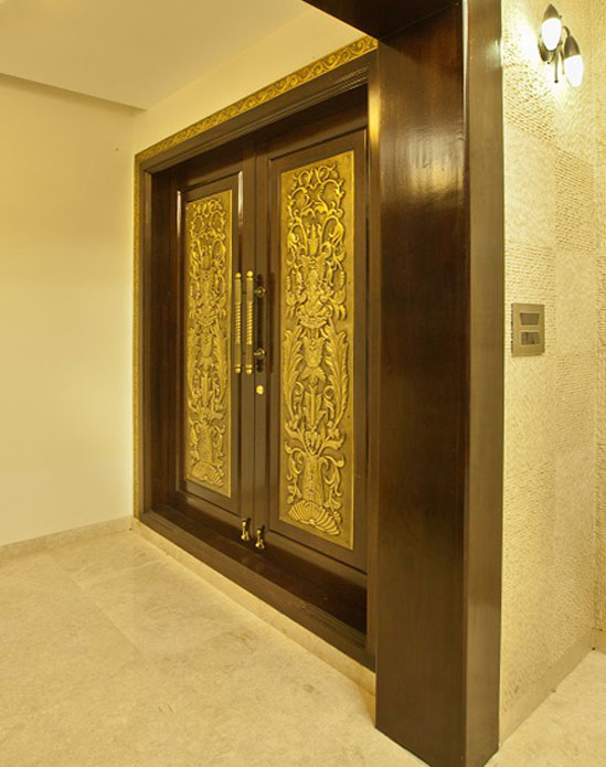 Intricate gold-accented entrance door,
										 elegant carved details, sophisticated entrance design